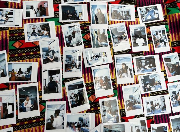 Polaroid photos of an event placed on a table for all to see.